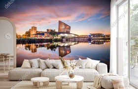 Wizualizacja fototapety z widokiem na oświetlone miasto Manchester i Imperialne muzeum wojny (Imperial War Museum) w Anglii z odbiciem w wodzie, o zmierzchu. Fototapeta do pokoju dziennego, młodzieżowego, sypialni, salonu, biura, gabinetu, przedpokoju i jadalni.